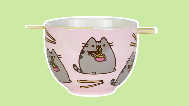 Pink Pusheen printed ramen bowl with chopsticks on top.