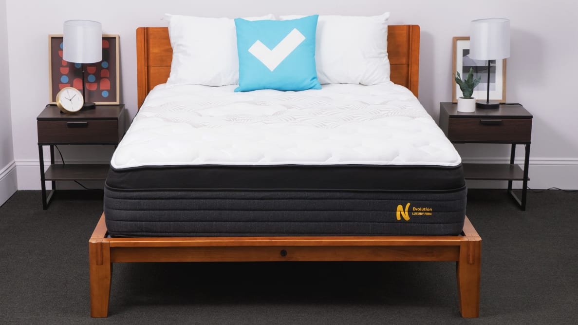 A bedroom with a Nolah Evolution 15 mattress and Reviewed, blue, pillow.