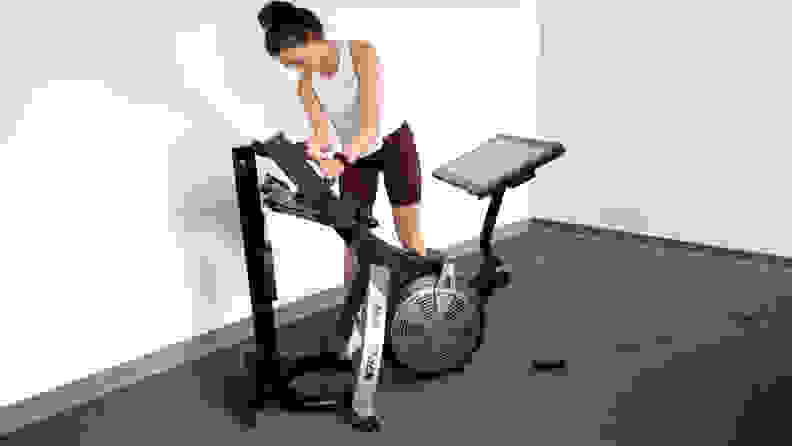 woman folding nordictrack RW 900 rowing machine.