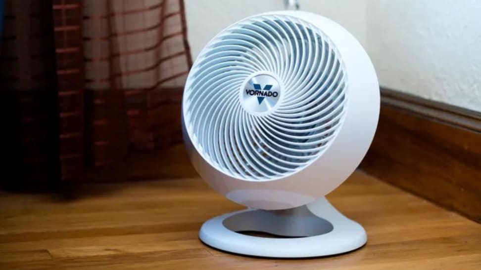 A white Vornado fan sitting on the floor.