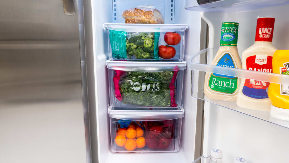 The Frigidaire FFSS2315TS's three crisper drawers, each filled with with fruits and vegetables.