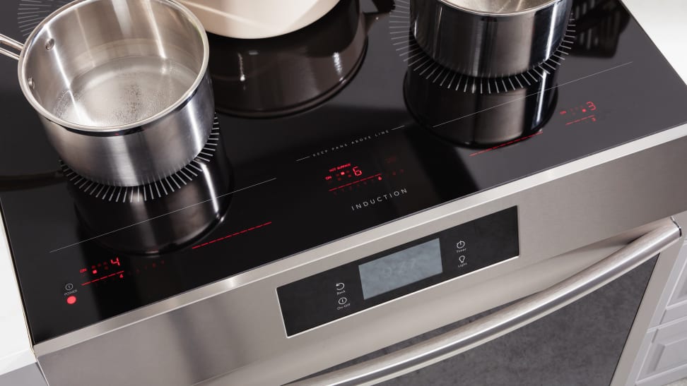 Several pieces of cookware laid out on a Frigidaire induction cooktop