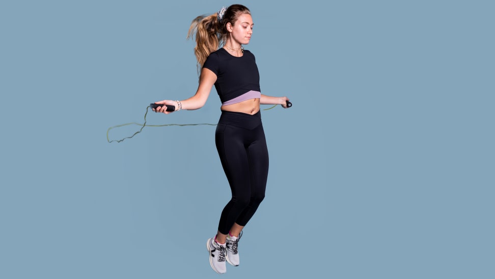 Person jumping rope while wearing workout clothing.