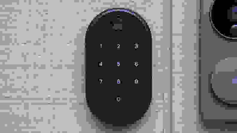 The advanced Yale Approach smart lock with the keypad shown in black, hanging on a door.