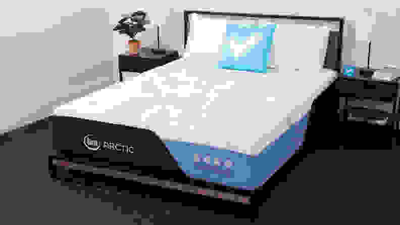 The Serta Arctic mattress appears in a bedroom with bedside tables on either side.