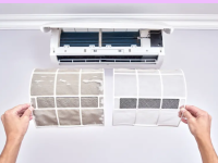 A person holding up two air conditioner filters. The left filter is dirty and the right is clean.