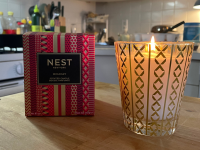 The Nest holiday candle on a kitchen counter.