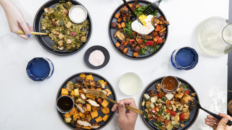 Array of Snap Kitchen prepared meals and snacks on a white countertop