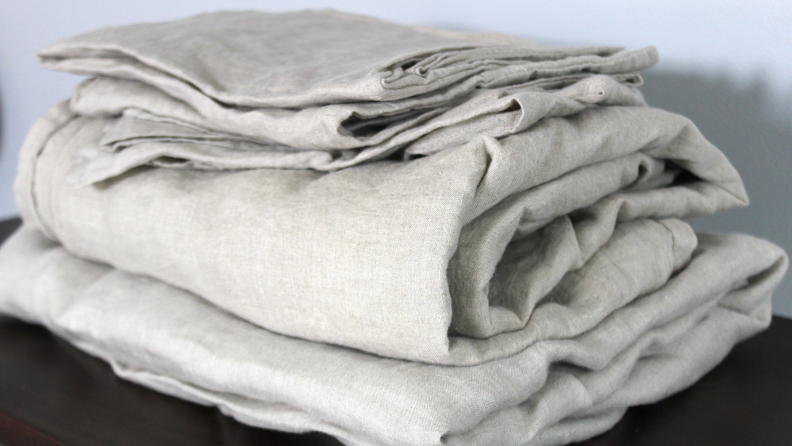 A stack of folded, white Avocado linen sheets