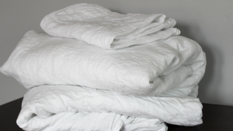 A stack of folded, white Brooklinen linen sheets