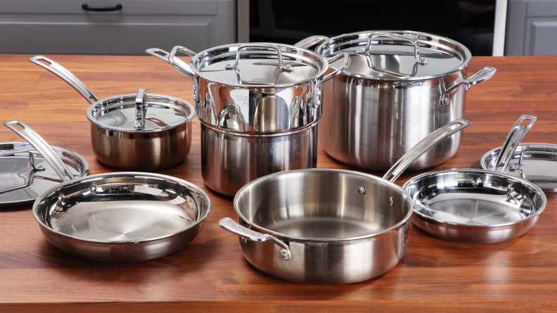 Cuisinart stainless steel set laid out on a wooden countertop