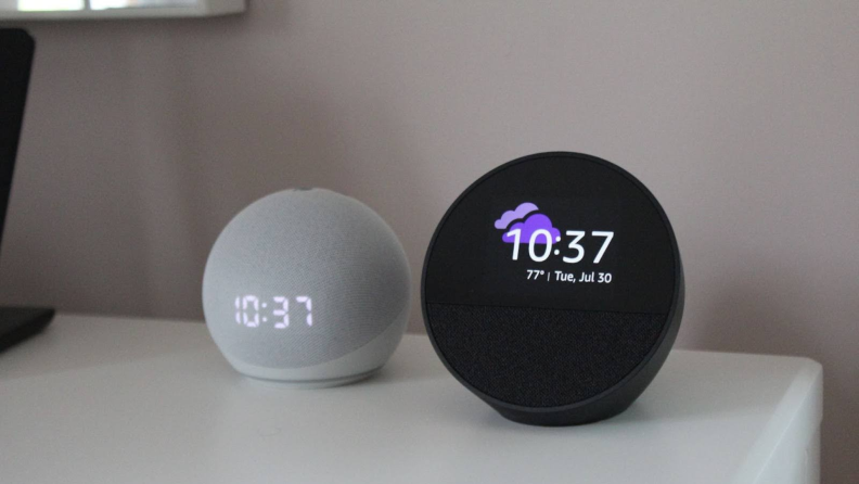 The Echo Spot and Echo Dot displayed side by side, with the clock display on both devices.