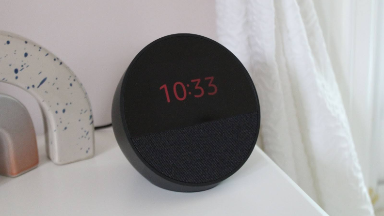 The Amazon Echo Spot in night mode, with dim red numbers on its screen.