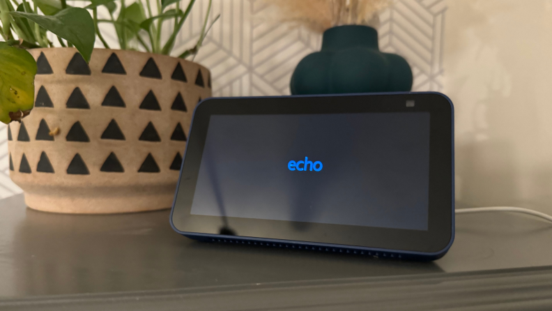 The Echo Show 5 in screensaver mode displaying the time.