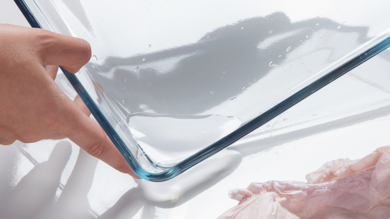 A small pool of water puddled in a glass tray.