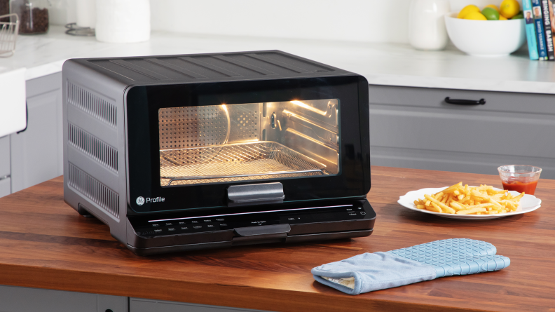 GE Profile Smart Oven on countertop next to plate of french fries