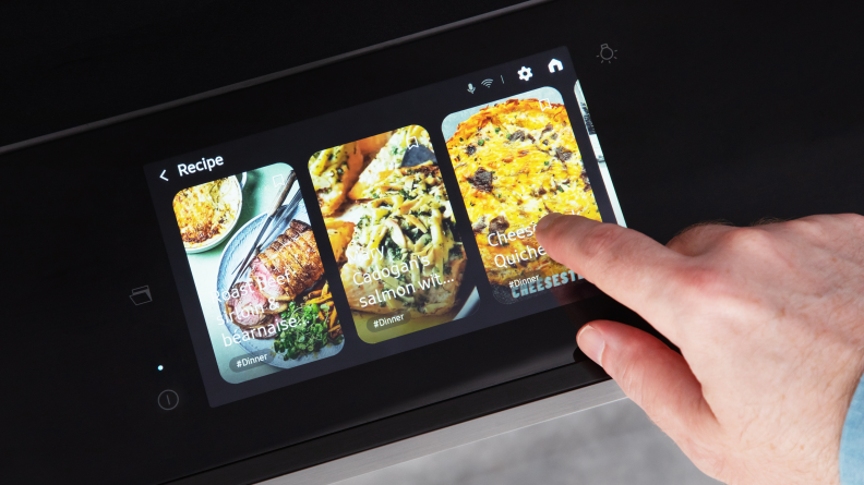 A person picking a recipe on the Samsung Bespoke NSI6DB990012AA Induction Range.