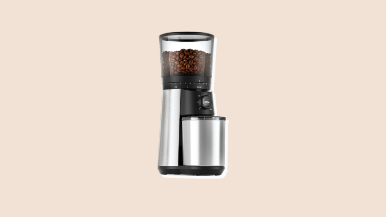 OXO Conical Burr grinder on beige background