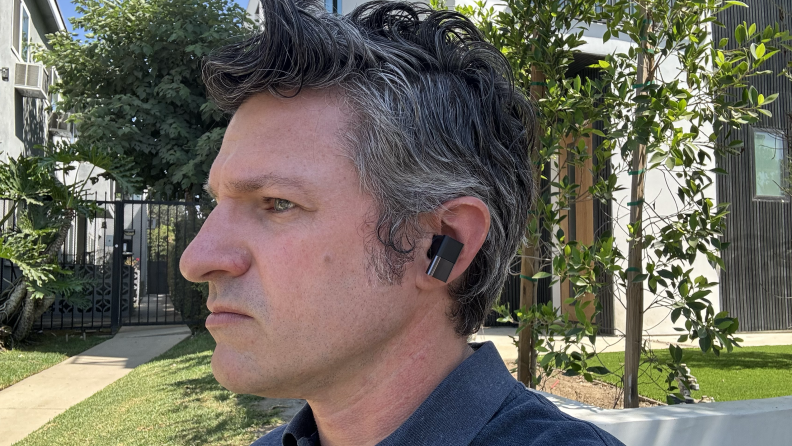 A man wearing the Status Audio Between 3ANC earbuds ourside.