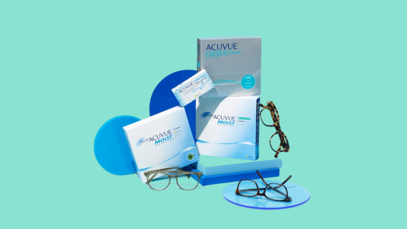 Several Acuvue contact lenses packages and eyeglasses floating on discs and boards of various blue hues.