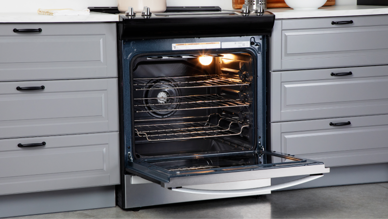 The Whirlpool WEE745H0LZ Electric Range with its door opened inside of a modern kitchen.