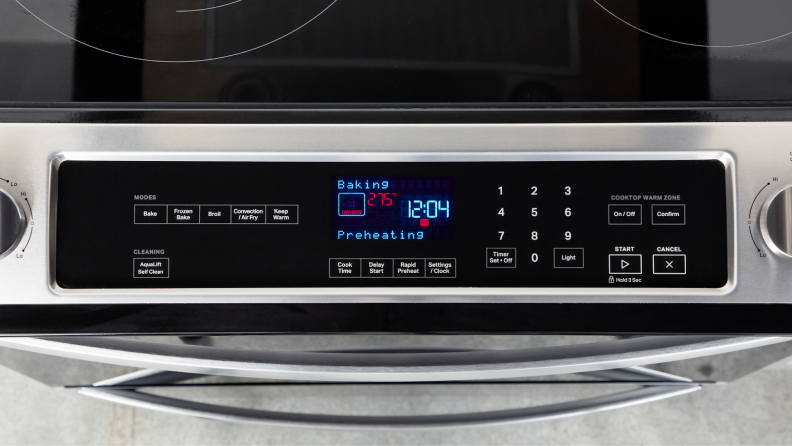 A closer view of the control panel and small screen displaying the time on the Whirlpool WEE745H0LZ Electric Range.